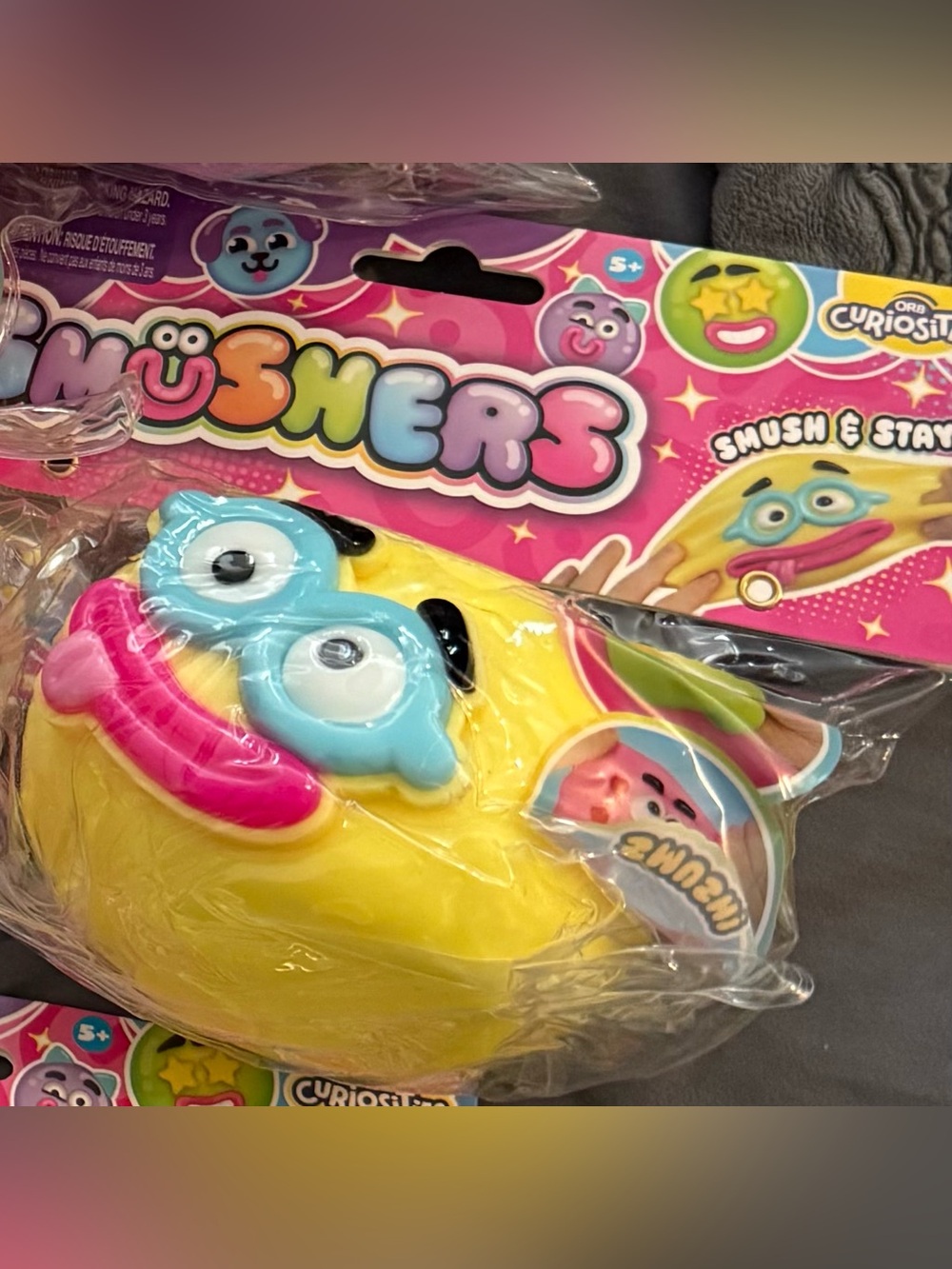 Authentic Smushers Yellow Funny Face Squishy with Blue Eyes and Pink Mouth